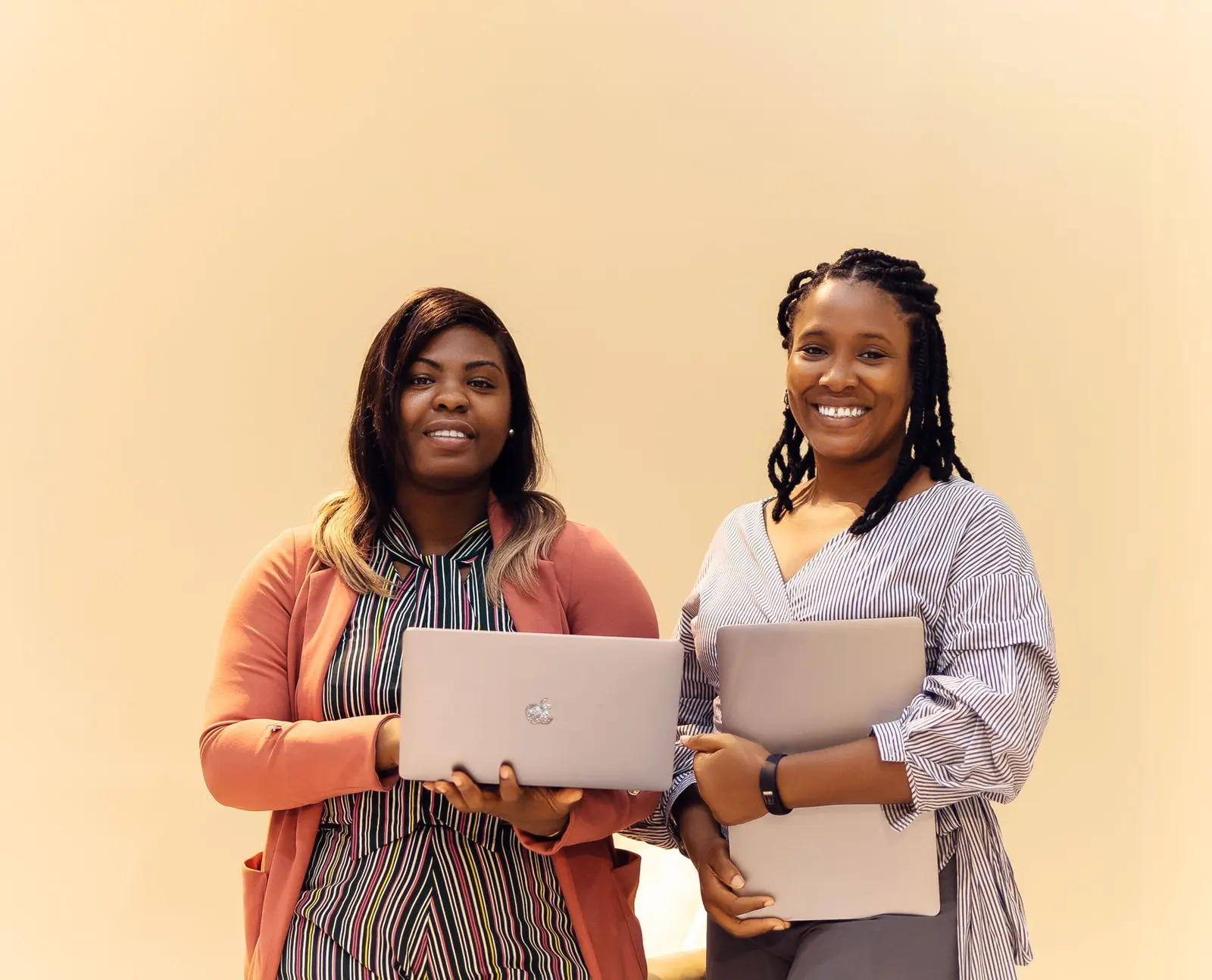 Two Nigerian businesswomen with laptops