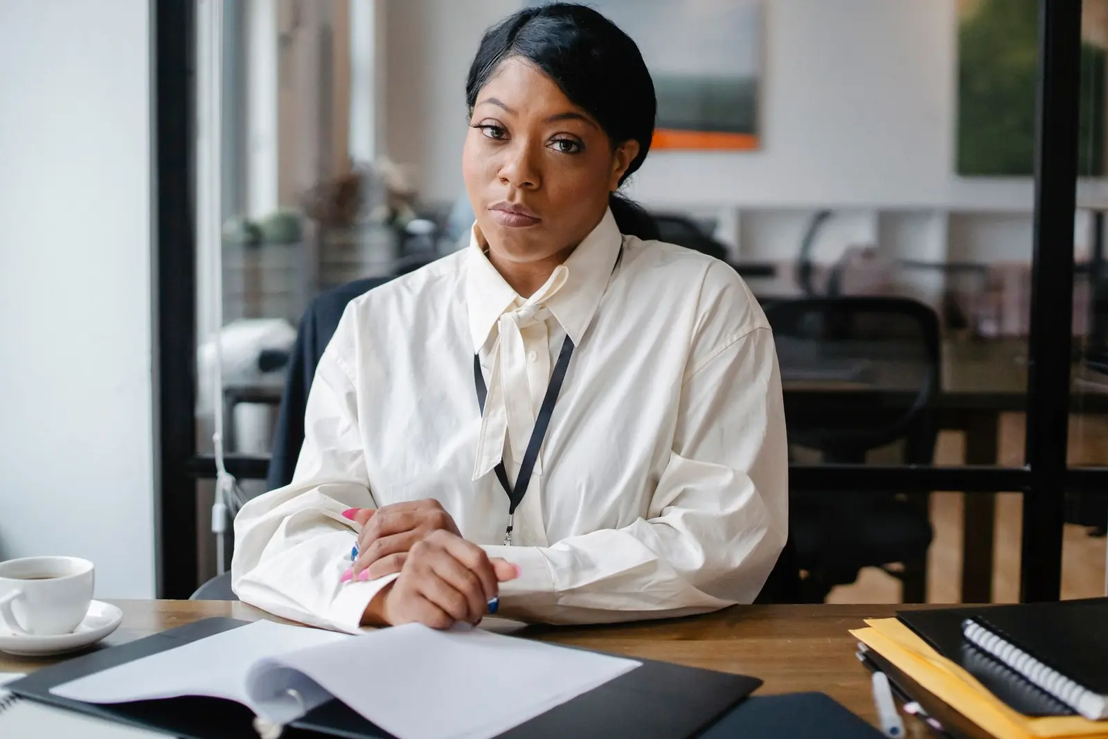 A Black human resources professional seated at a desk