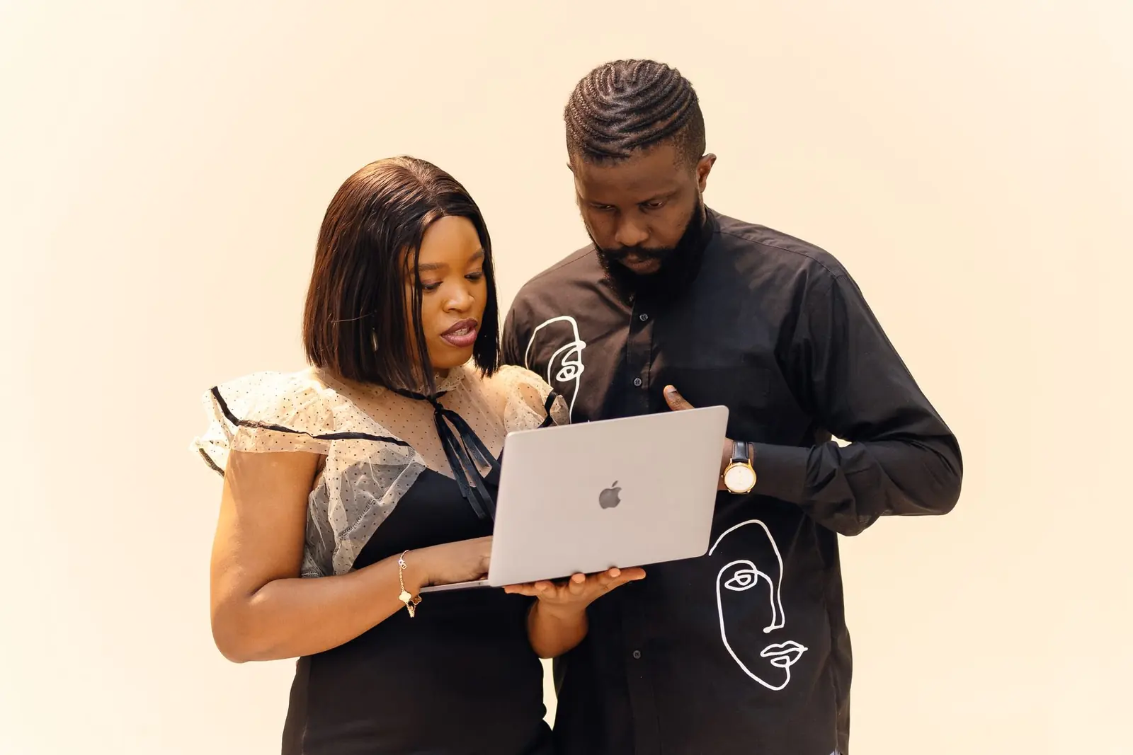 Nigerian professionals collaborating on a laptop