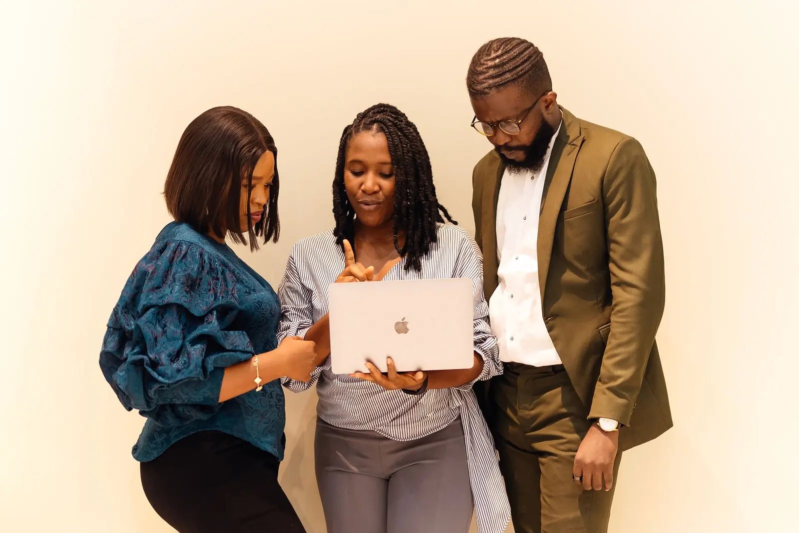 Nigerian colleagues reviewing work together on a laptop